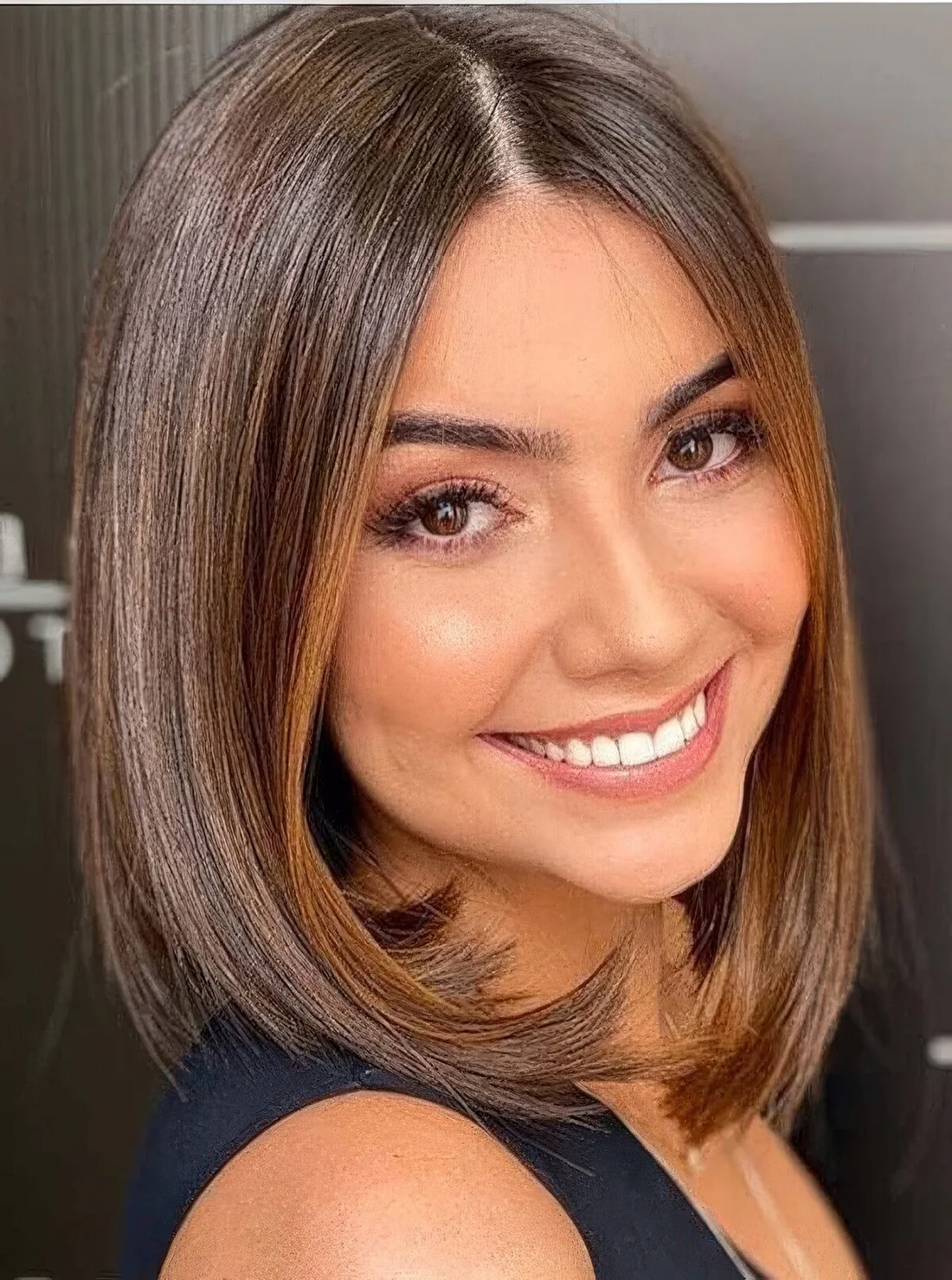 Long chestnut bob with curled ends.