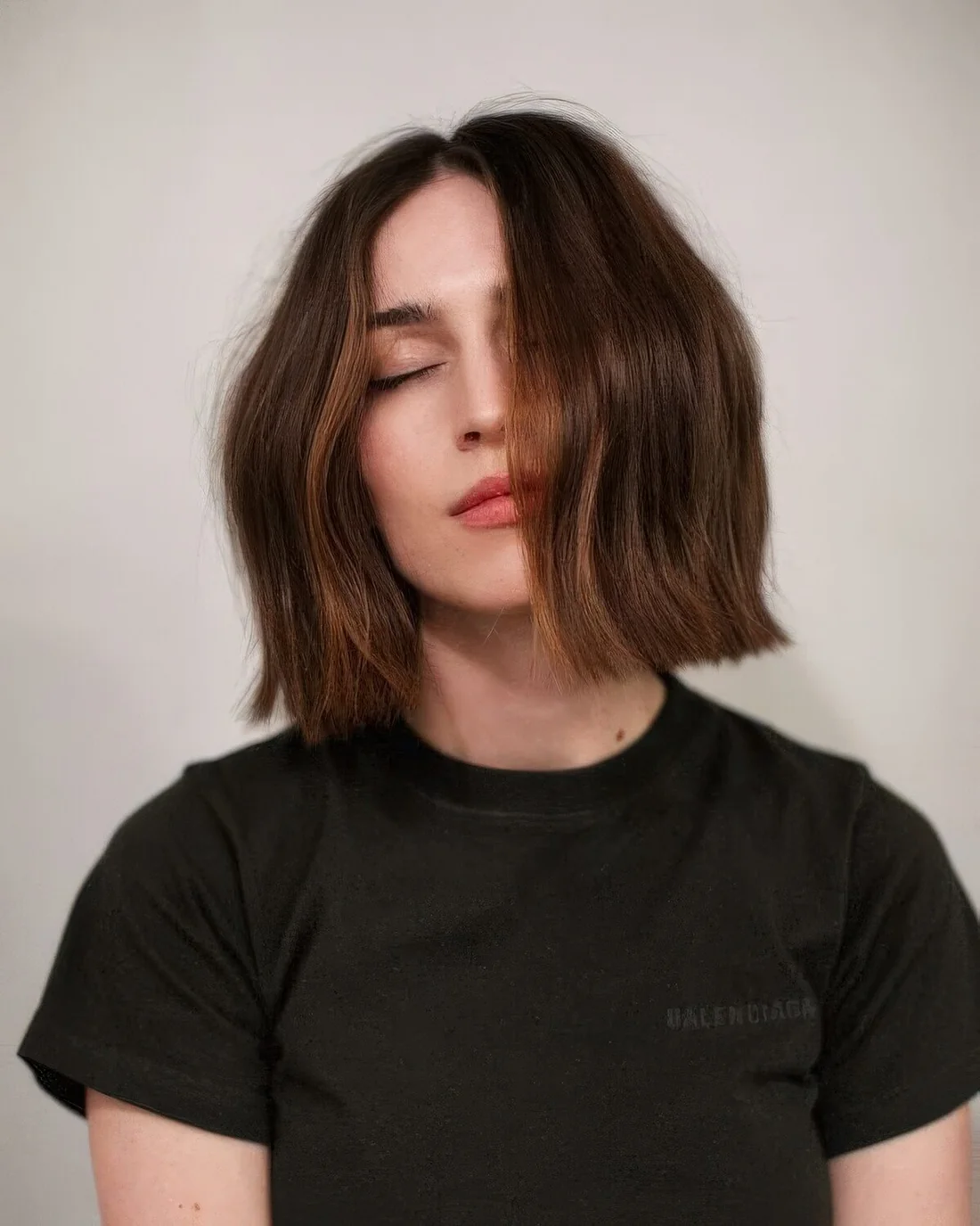 Photo showing long chestnut bob with waves, with the hairstyle clearly visible.