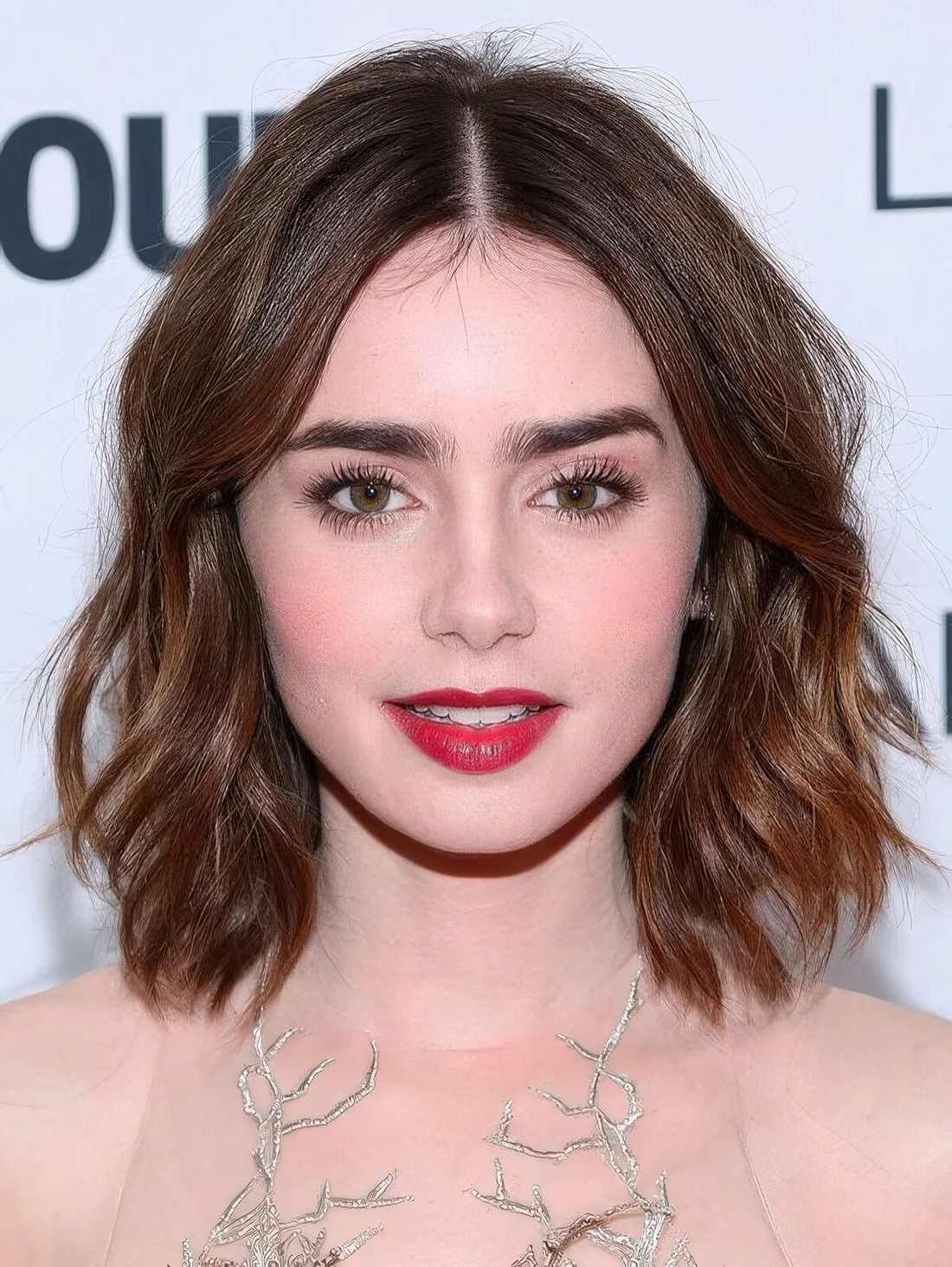 Long and wavy chestnut bob with a messy touch.