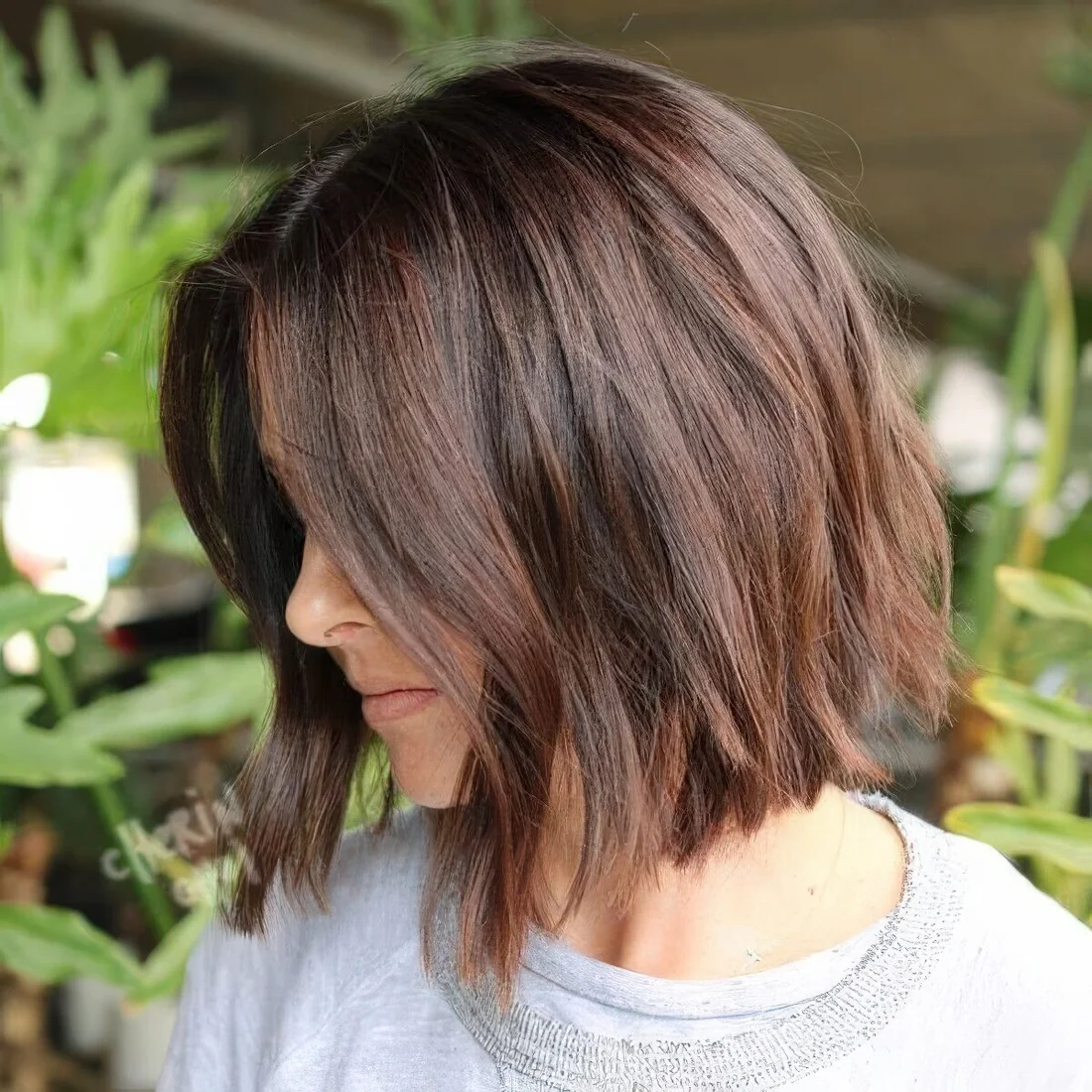 Messy midi length wavy bob in chestnut shades.