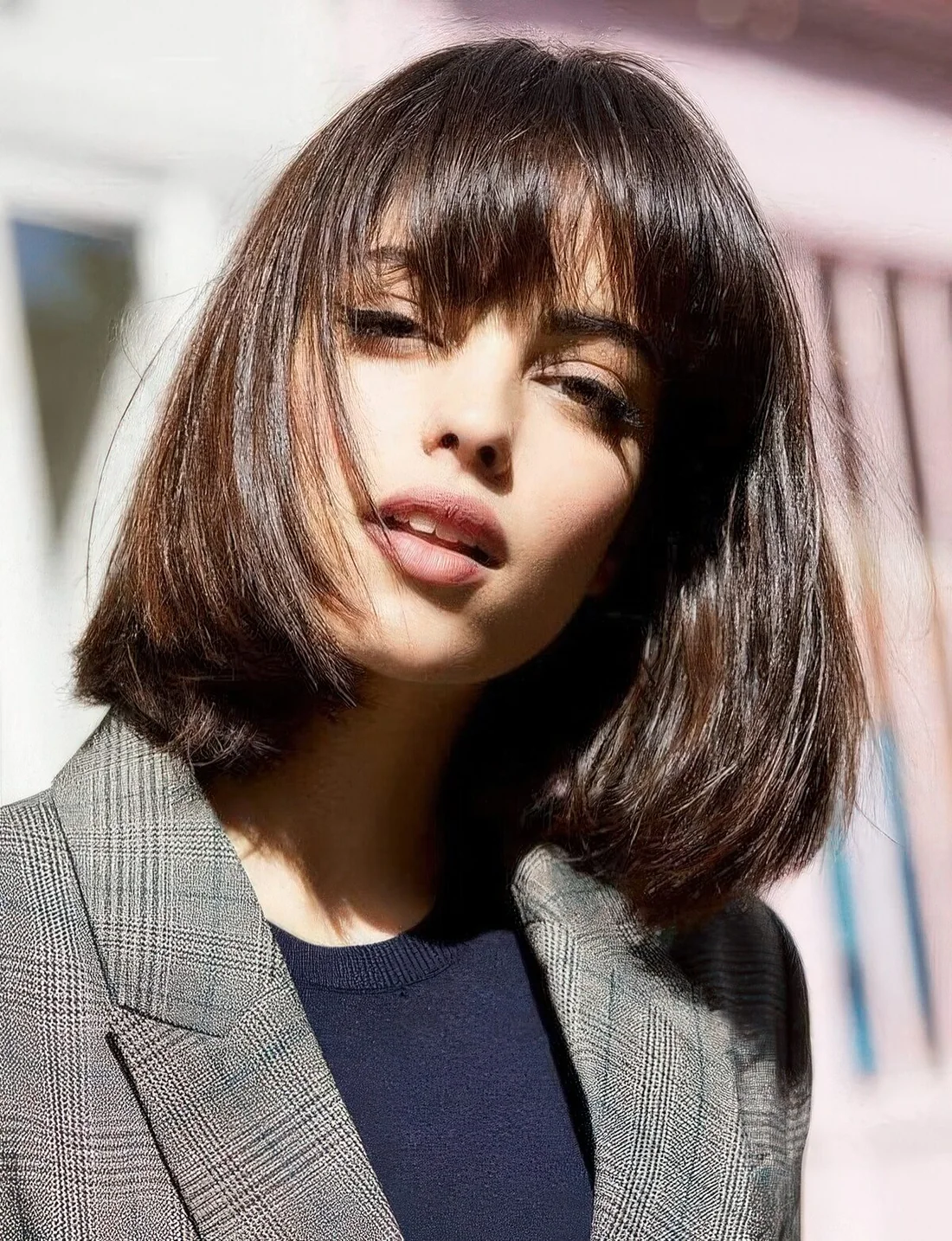 Shiny chestnut long bob with a classic fringe, with a lot of volume and curved ends.