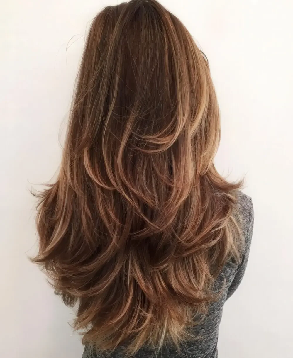 Long layered haircut with highlights.