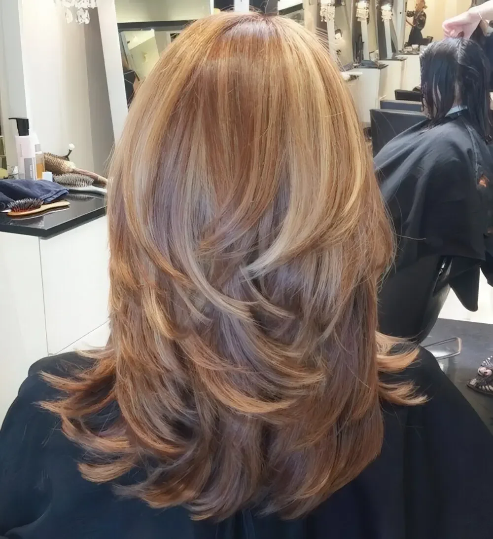 Thick balayage fair hair wwith stylish layers.