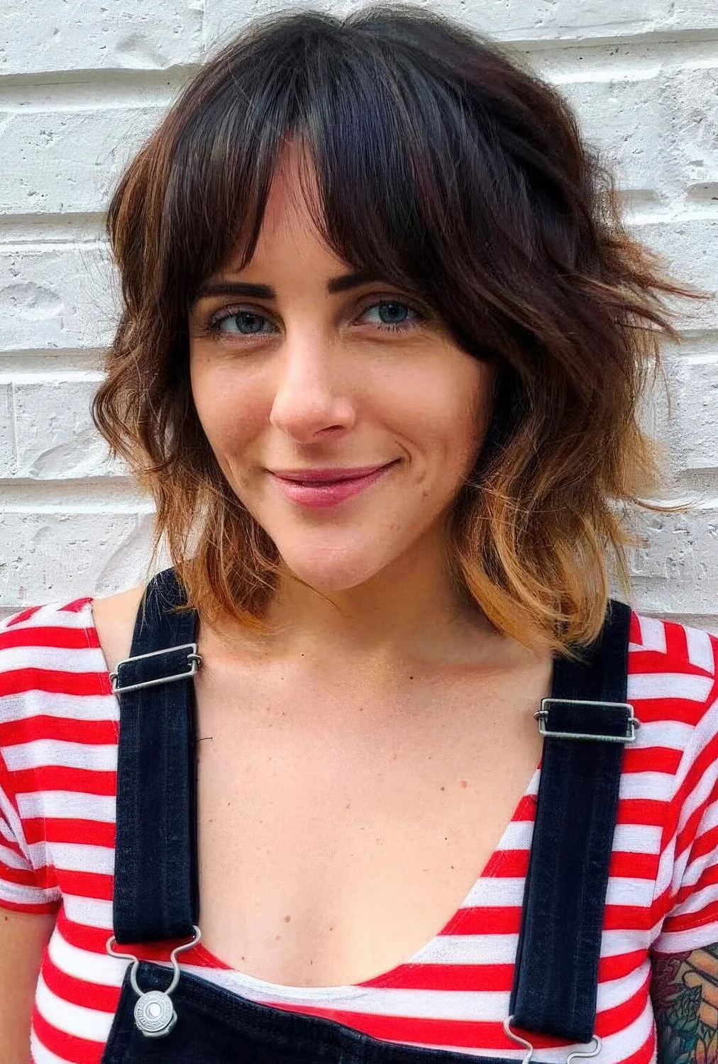 Dark brunette long bob with bottleneck bangs and caramel ombre plus shaggy waves.
