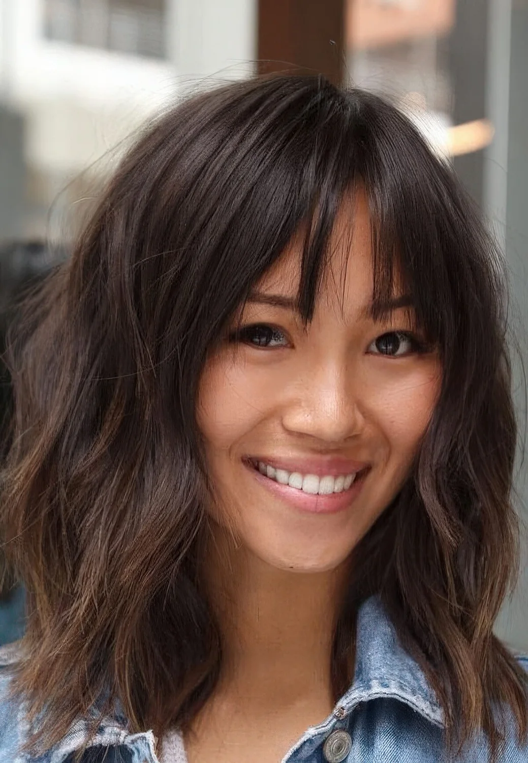 Layered lob with bottleneck bangs and a rich brown tone.