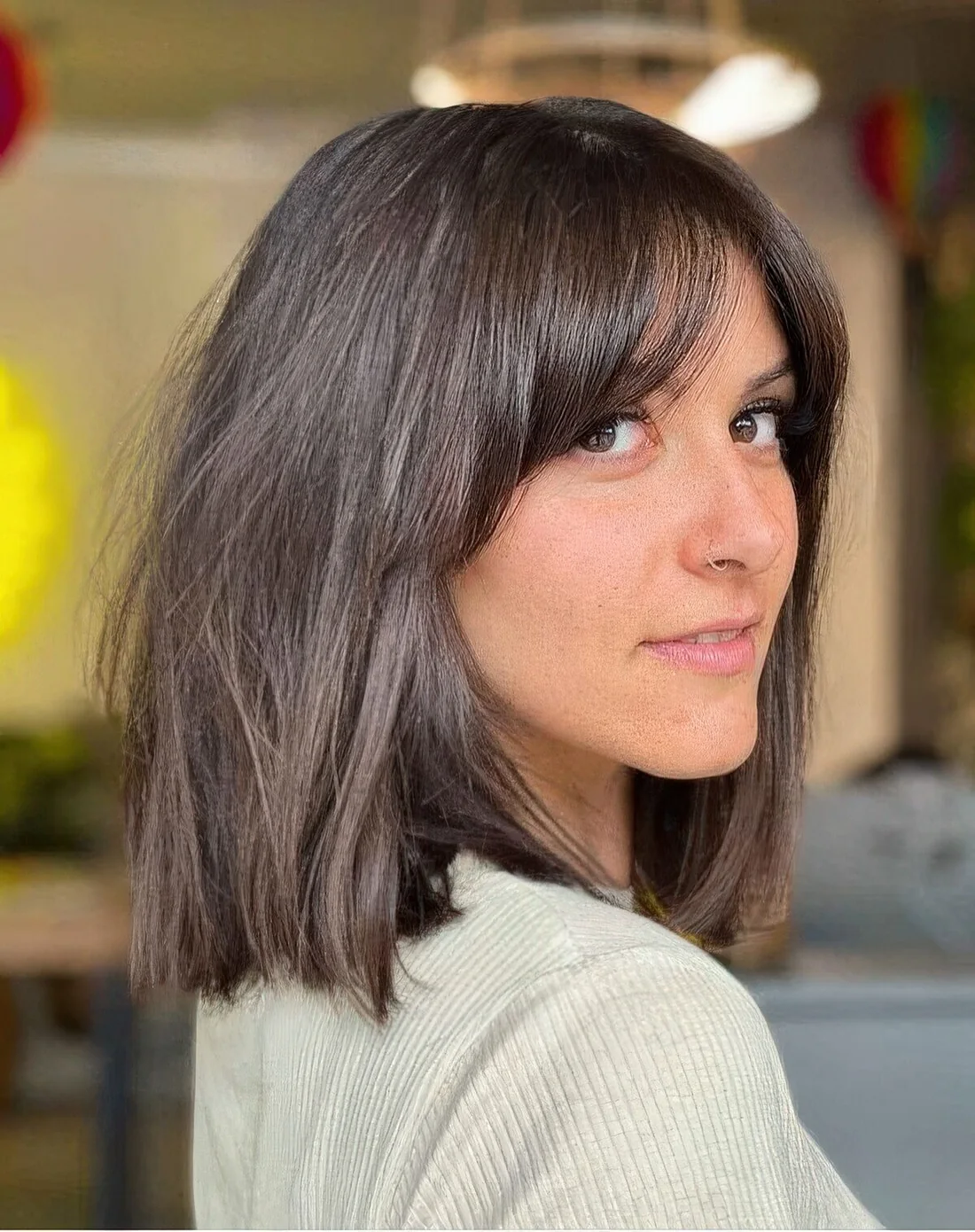 Dark brunette long bob with bottleneck bangs paired with curtain ones.