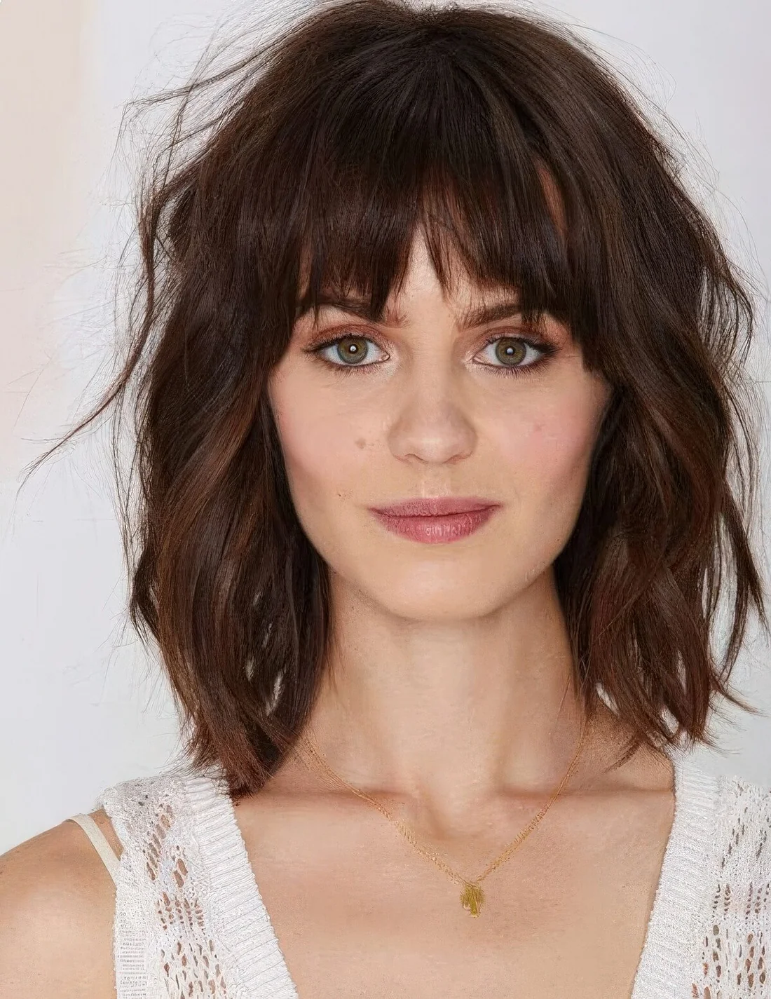 Dark brunette long bob with bottleneck bangs, waves and a lot of dimension.