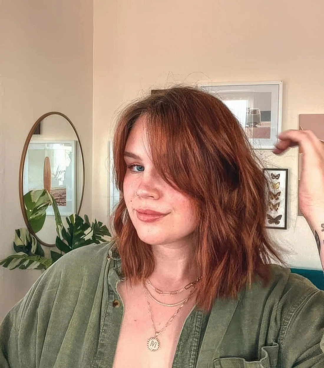 Ginger long bob with curtain bangs and messy waves.