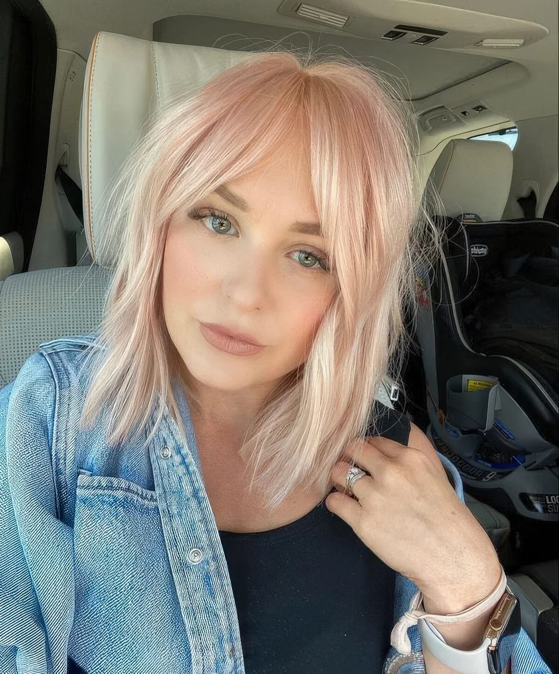 Light pink long bob with curtain bangs.