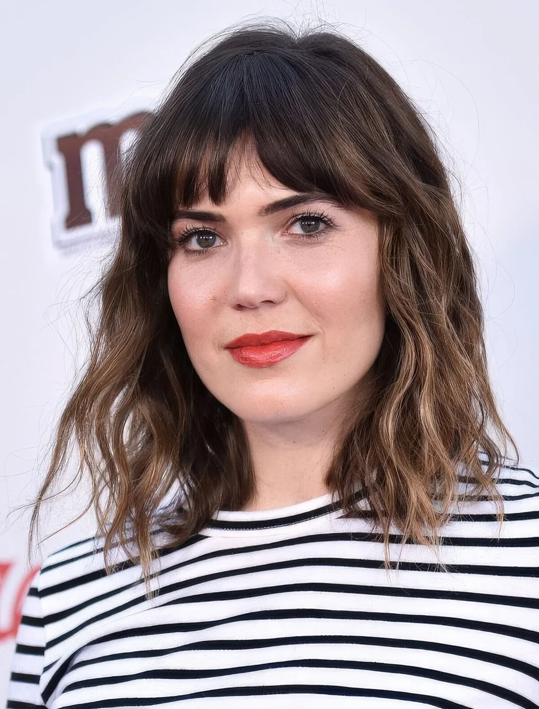 Long dark brunette bob with bronde balayage, bottleneck bangs and waves.