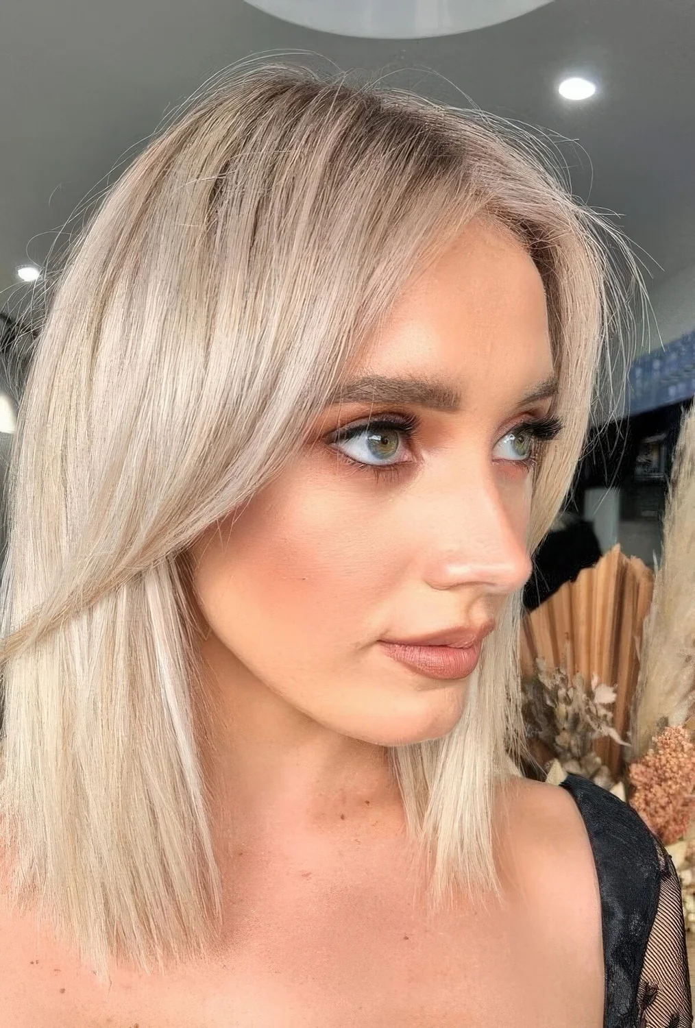 Long platinum bob with curtain bangs.