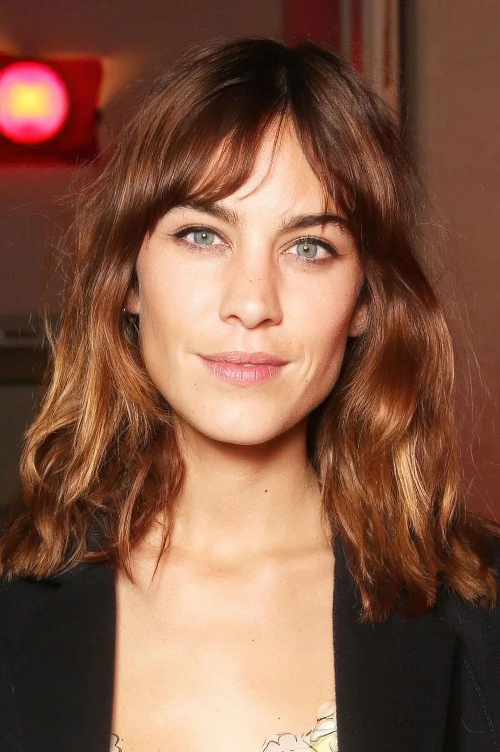 Auburn long bob with copper and caramel balayage, bottleneck bangs and waves.