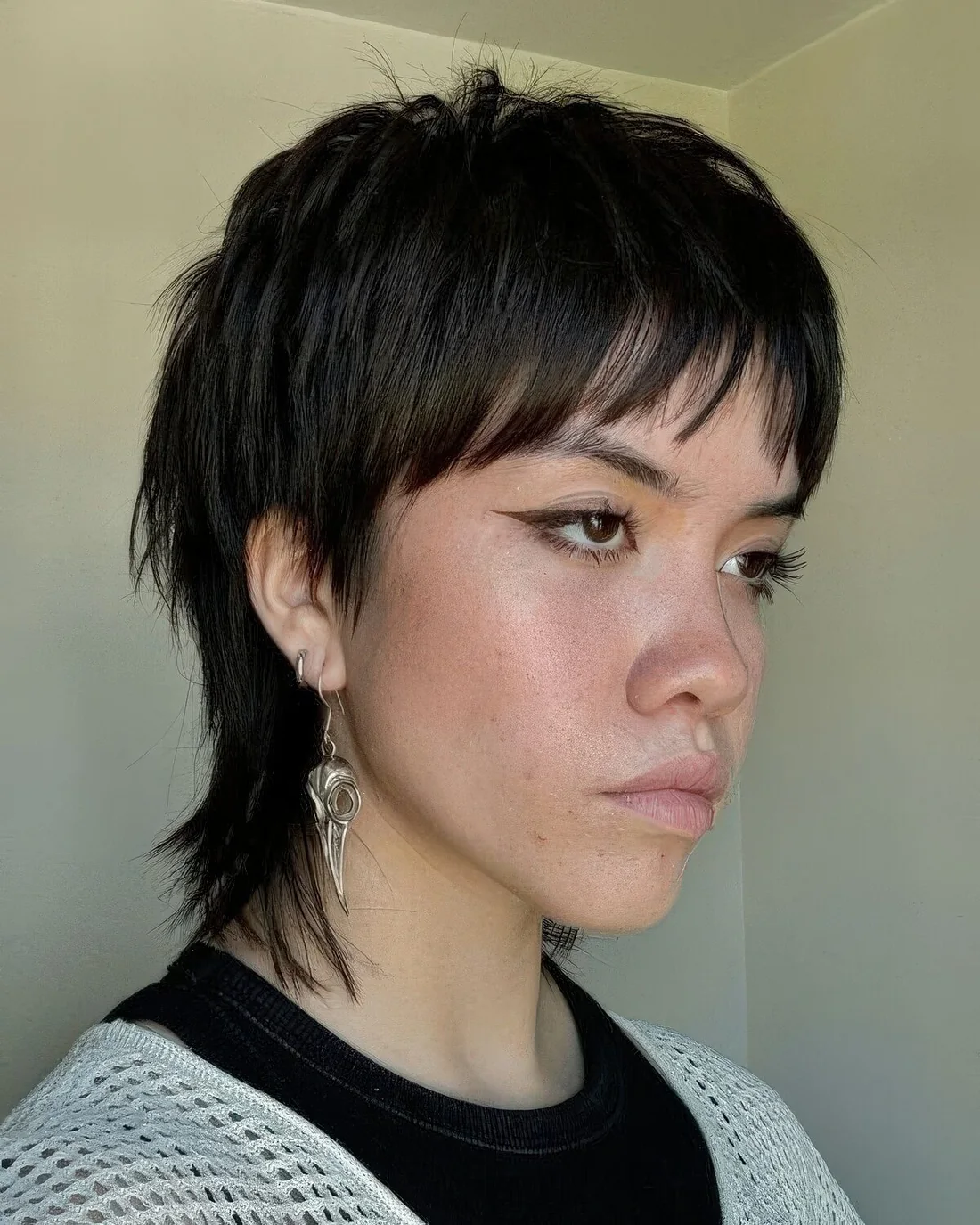 Photo showing black mullet bangs, with the hairstyle clearly visible.