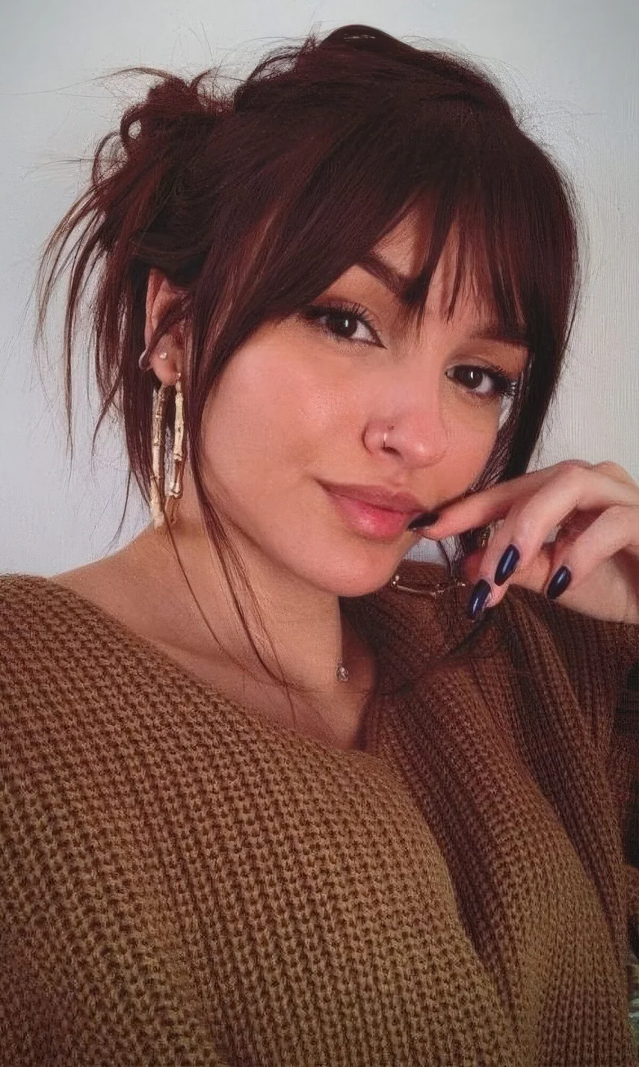 Photo showing cherry red hair choppy bangs, with the hairstyle clearly visible.