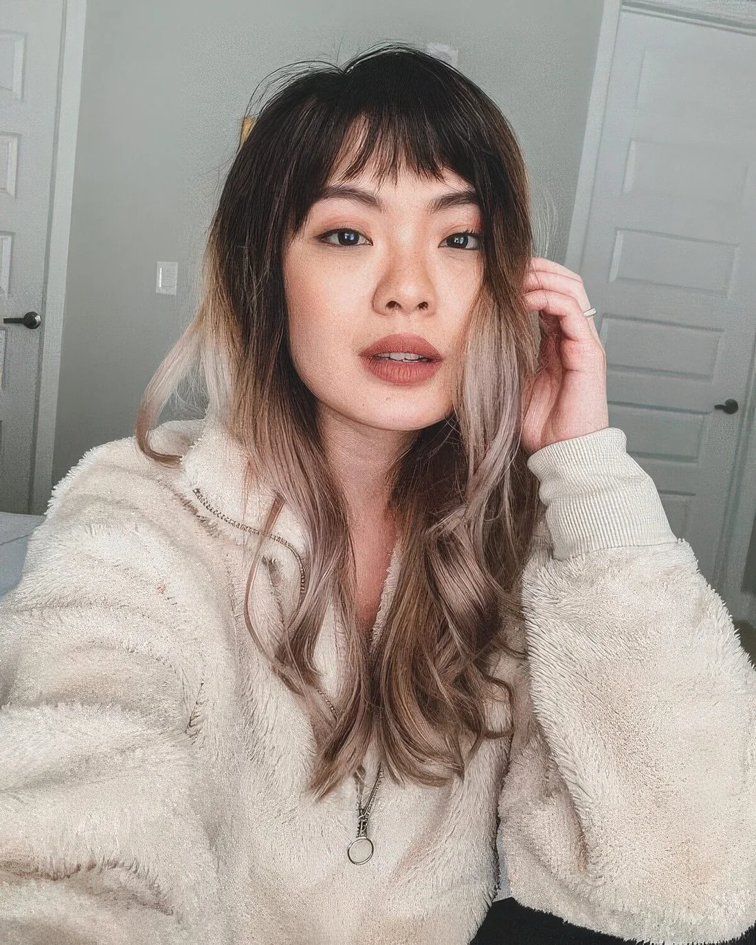 Photo showing long ombre choppy bangs, with the hairstyle clearly visible.