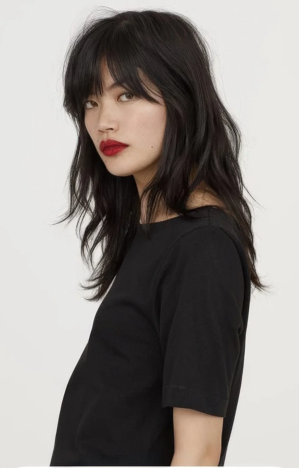 Photo showing long shaggy cut choppy bangs, with the hairstyle clearly visible.