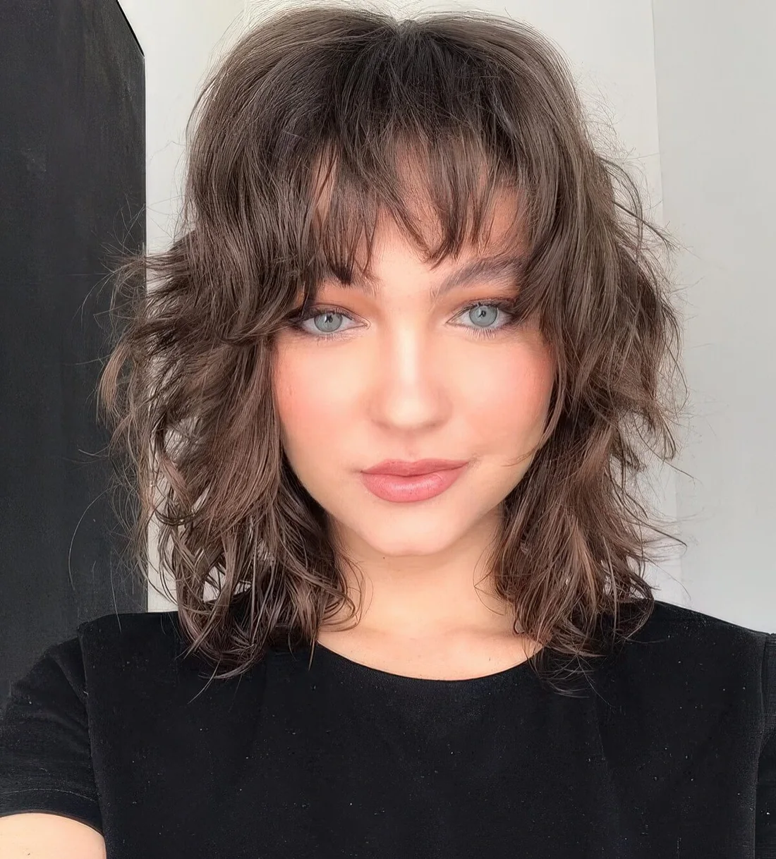 Photo showing shaggy cut and bangs, with the hairstyle clearly visible.