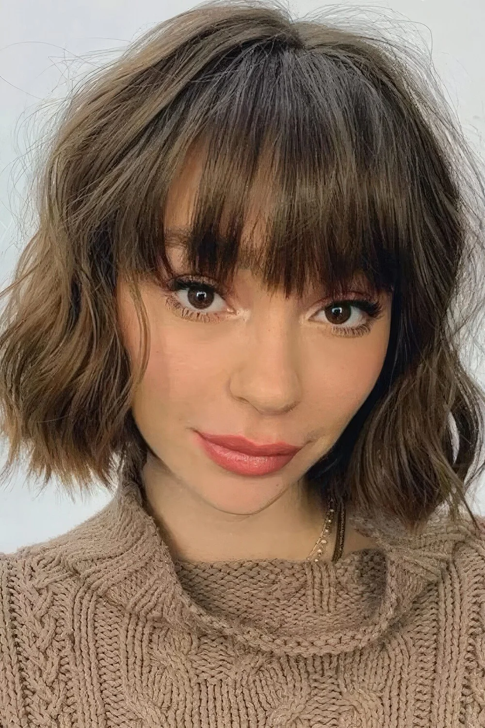 Photo showing wavy choppy bob and bangs, with the hairstyle clearly visible.