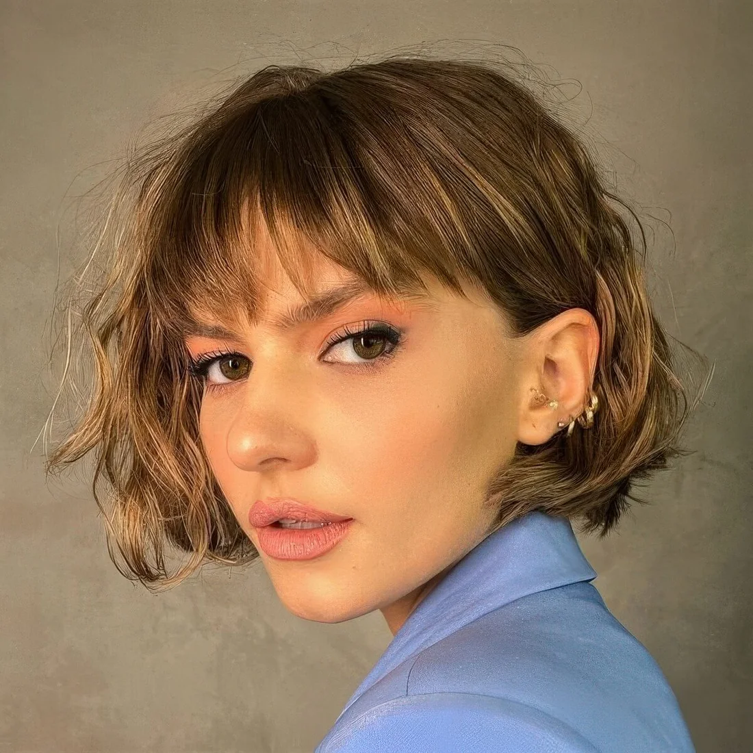 Photo showing wavy ear bob, with the hairstyle clearly visible.