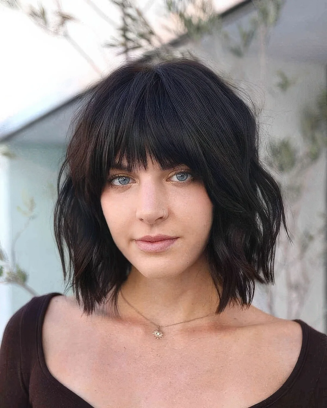 Black choppy bob with bangs and waves.