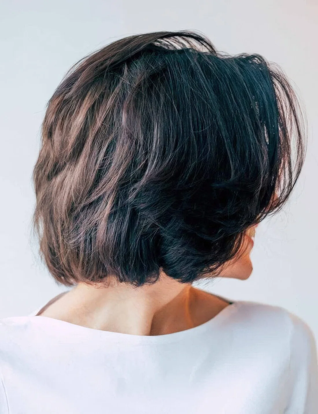 Black choppy bob with center parted bangs that help to freshen things up.
