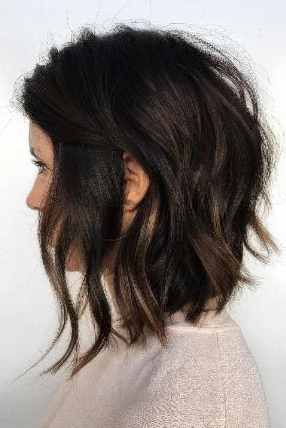 Black choppy bob with lowlights and waves.