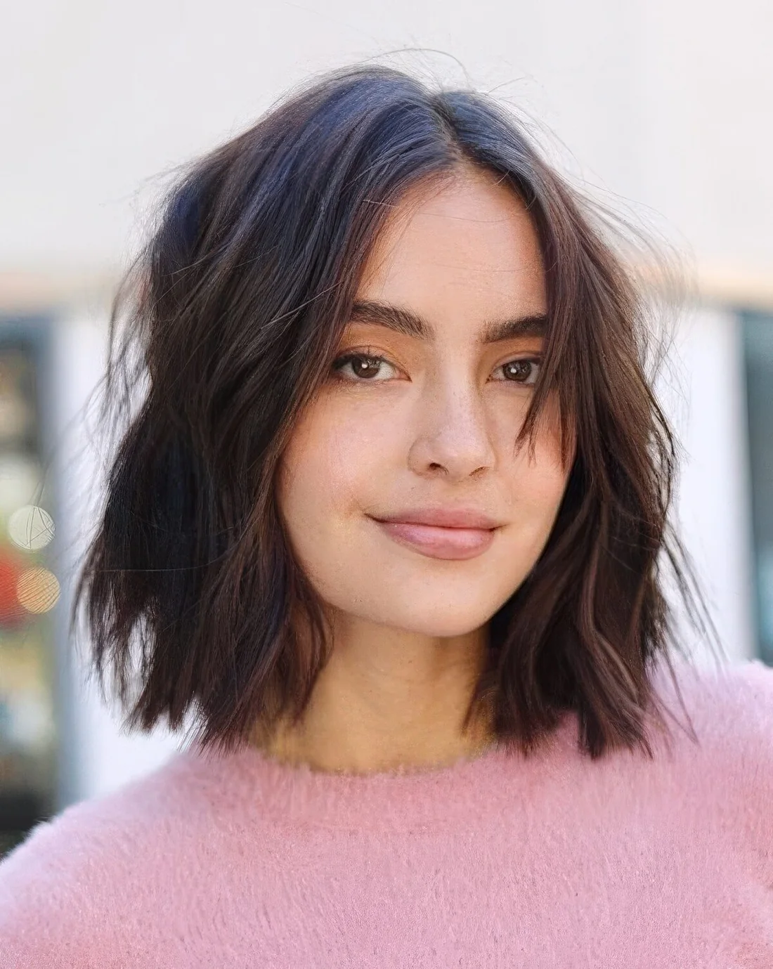Brown choppy bob with short bangs and a lot of texture, with center part.