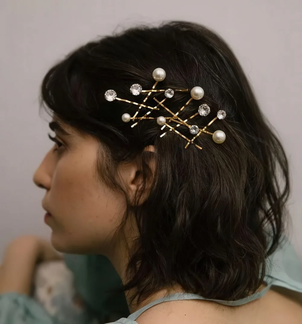 Photo showing rhinestone and pearl pins, with the hairstyle clearly visible.