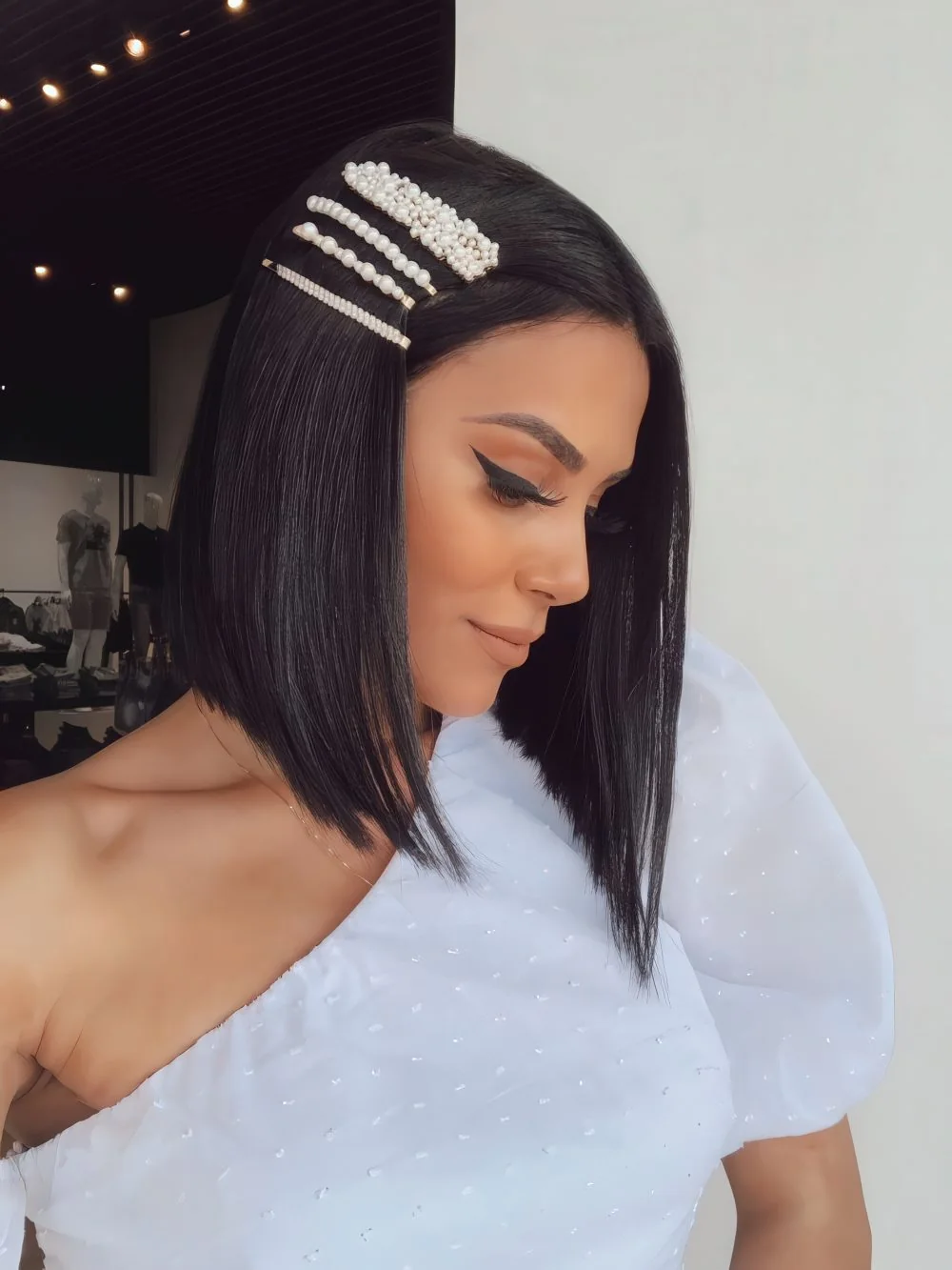 Photo showing pearl hair pins, with the hairstyle clearly visible.