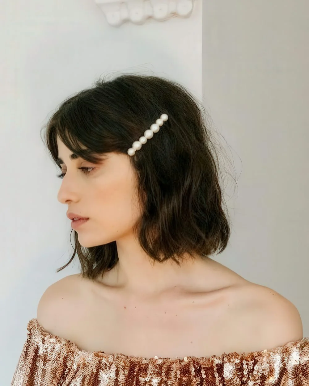 Photo showing pearl hair pin, with the hairstyle clearly visible.