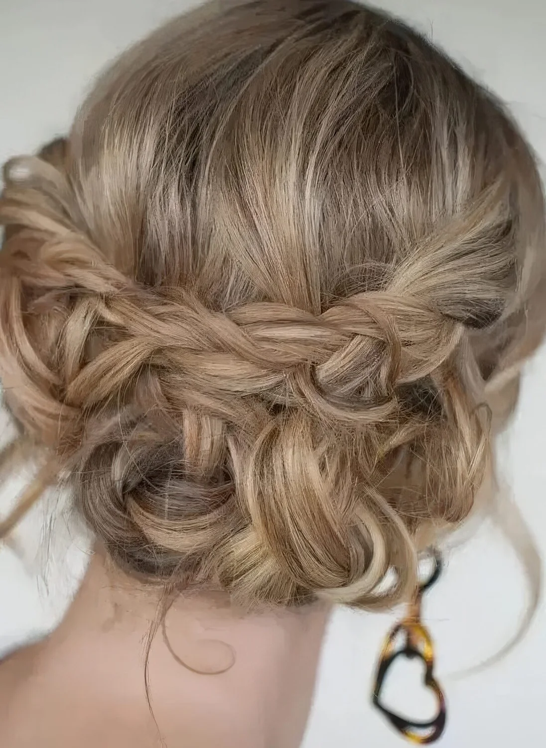 Boho updo with braids and twists and some waves down plus a bump on top.
