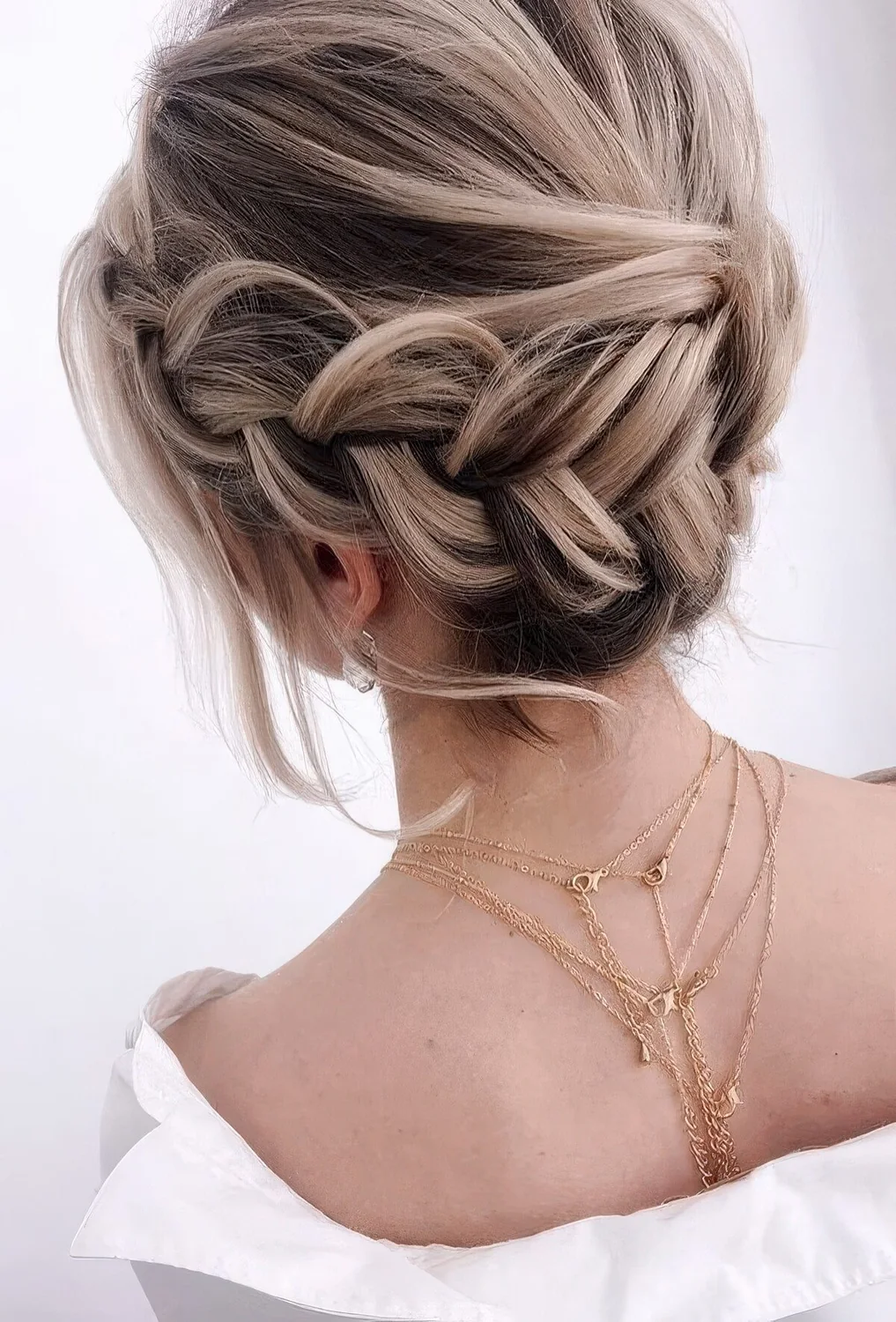 Braided halo low updo with a volume on top, some waves down.