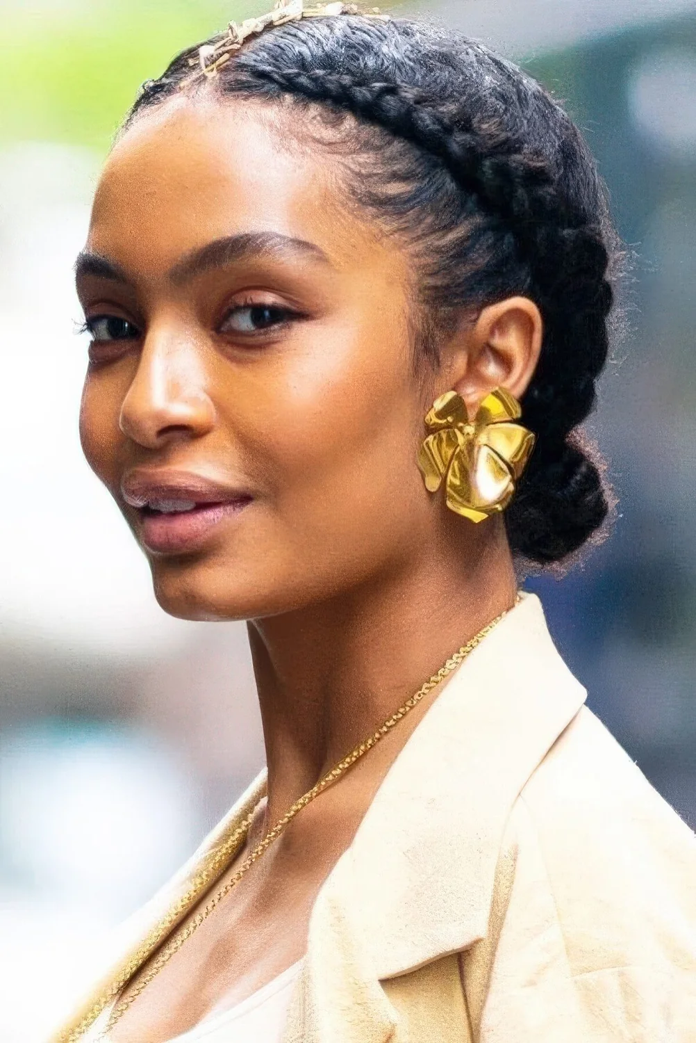 Braided low bun and braids on both sides of the head are a great and catchy holiday updo.