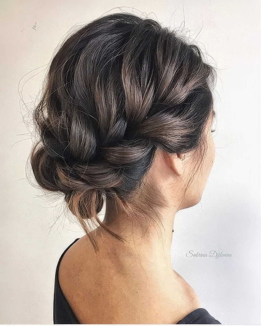 Braided updo with a loose halo and a bump on top.