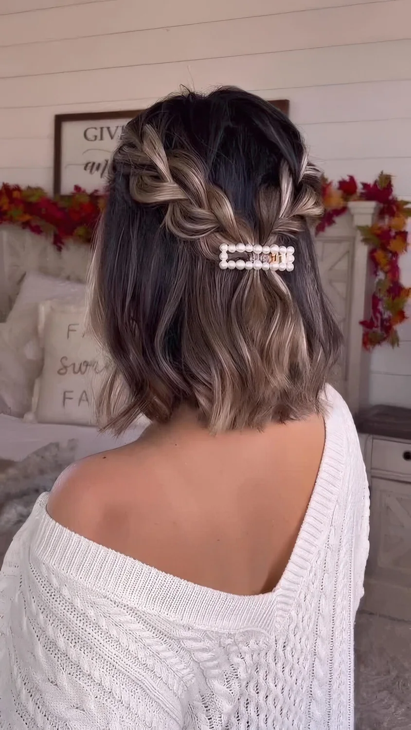 Half updo with braids, waves and a pretty pearl hair piece.