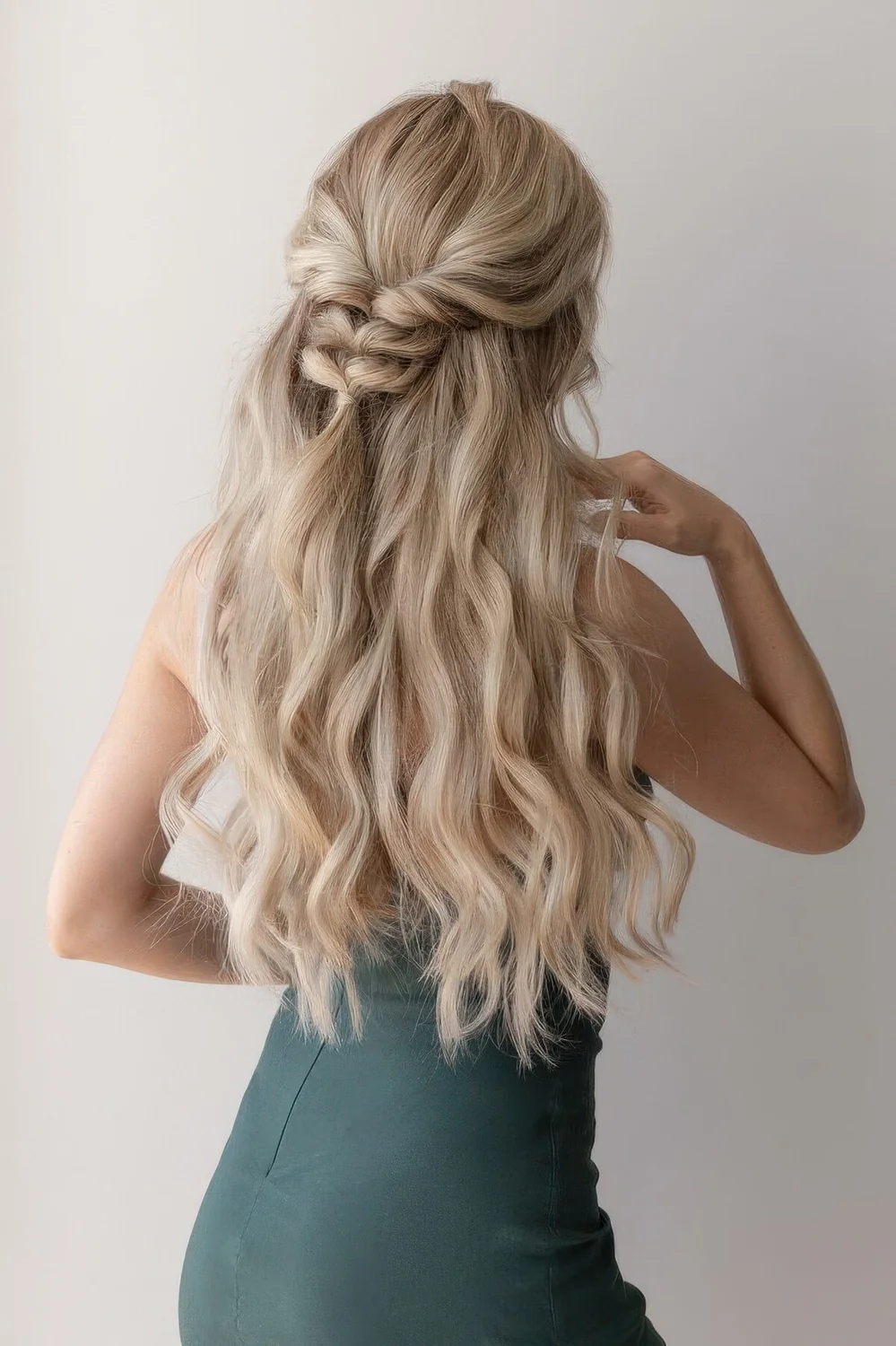 Half updo with a volume on top, waves and a loose braid.