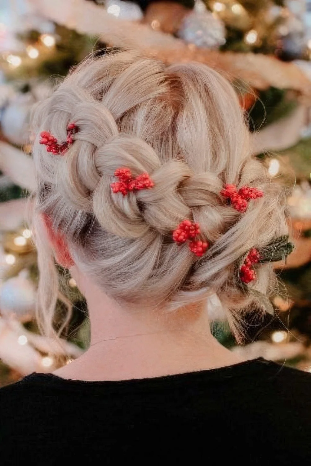 Creative and fun holiday updo with a large braid and red berries tucked in.