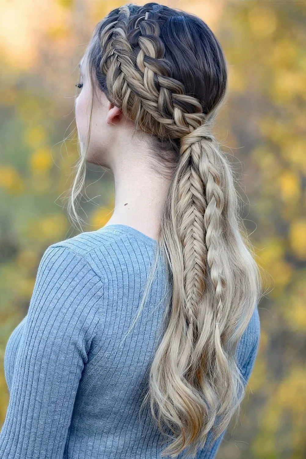 Creative braided ponytail with a double side braid and waves down.