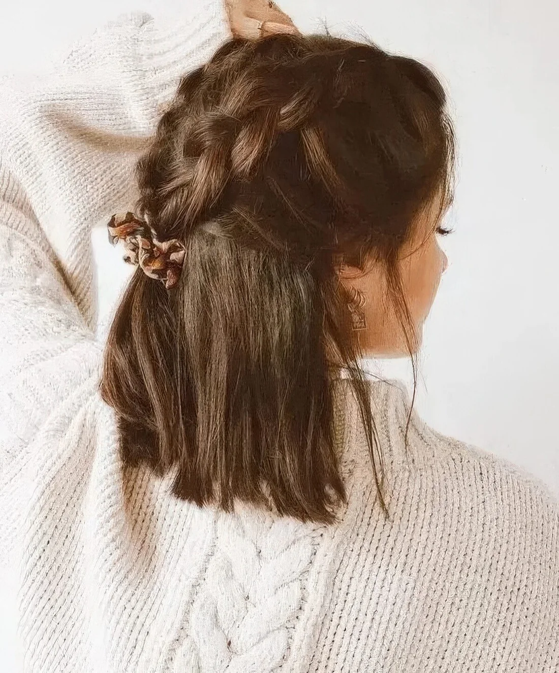 Creative dark brown half-up wedding hairstyle with large braids on top and hair down.