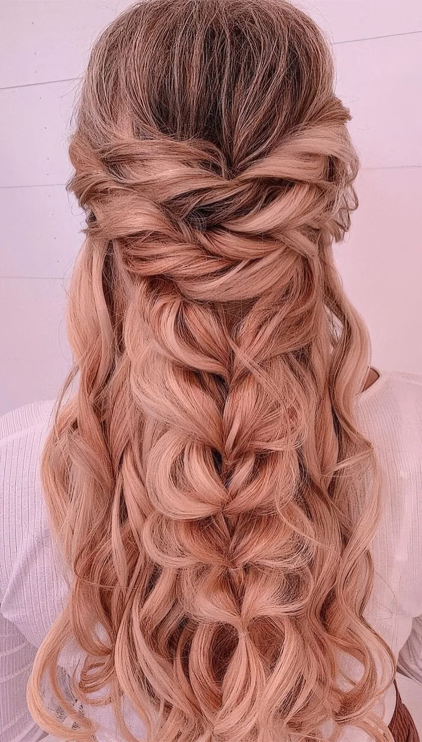 Volumetric half updo with twists, a loose braid and waves down.