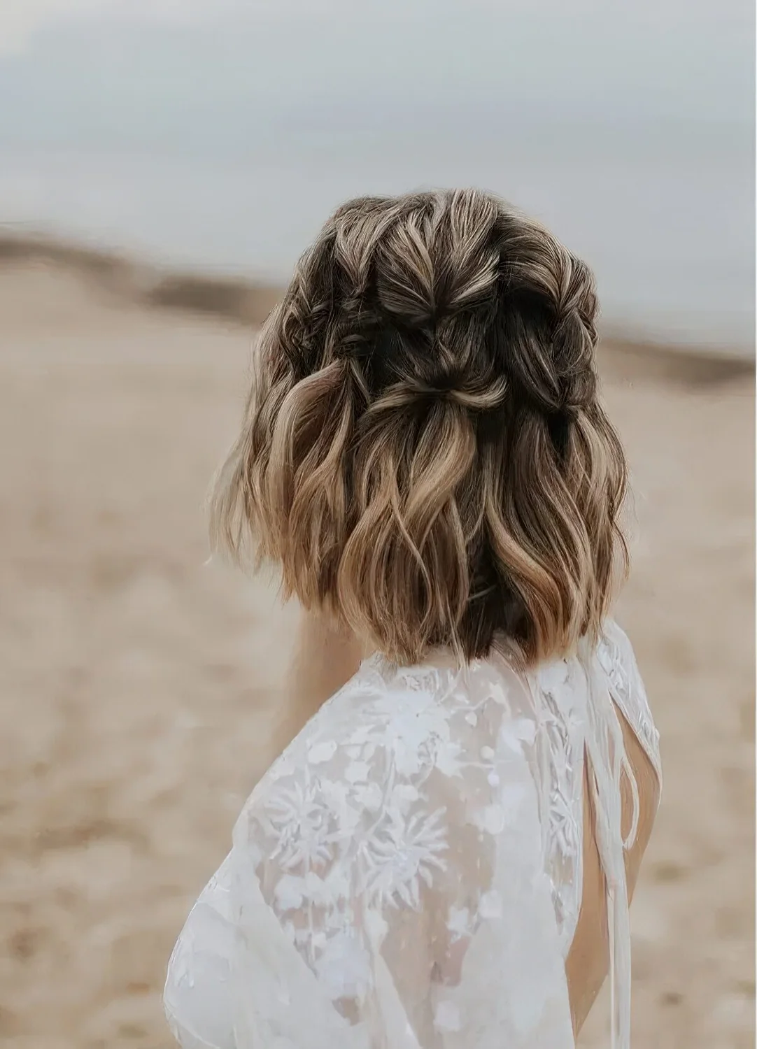 Brown long bob with blonde and caramel balayage and braids all over the head.