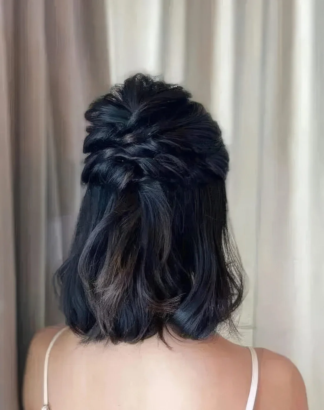 Half updo with twisted halos and a bump on top and some waves down.