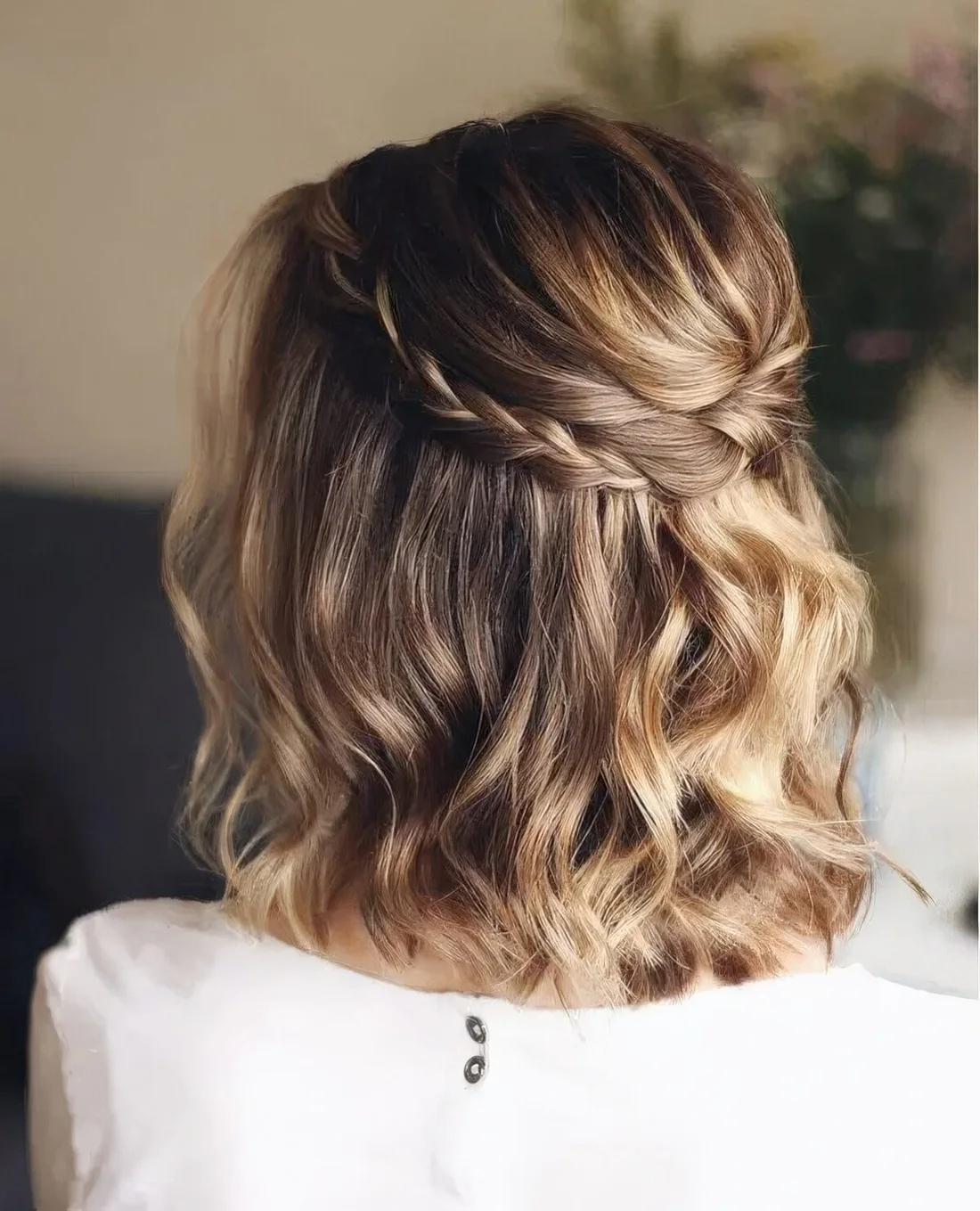 Light brown long bob with golde blonde balayage, waves and a braided halo.