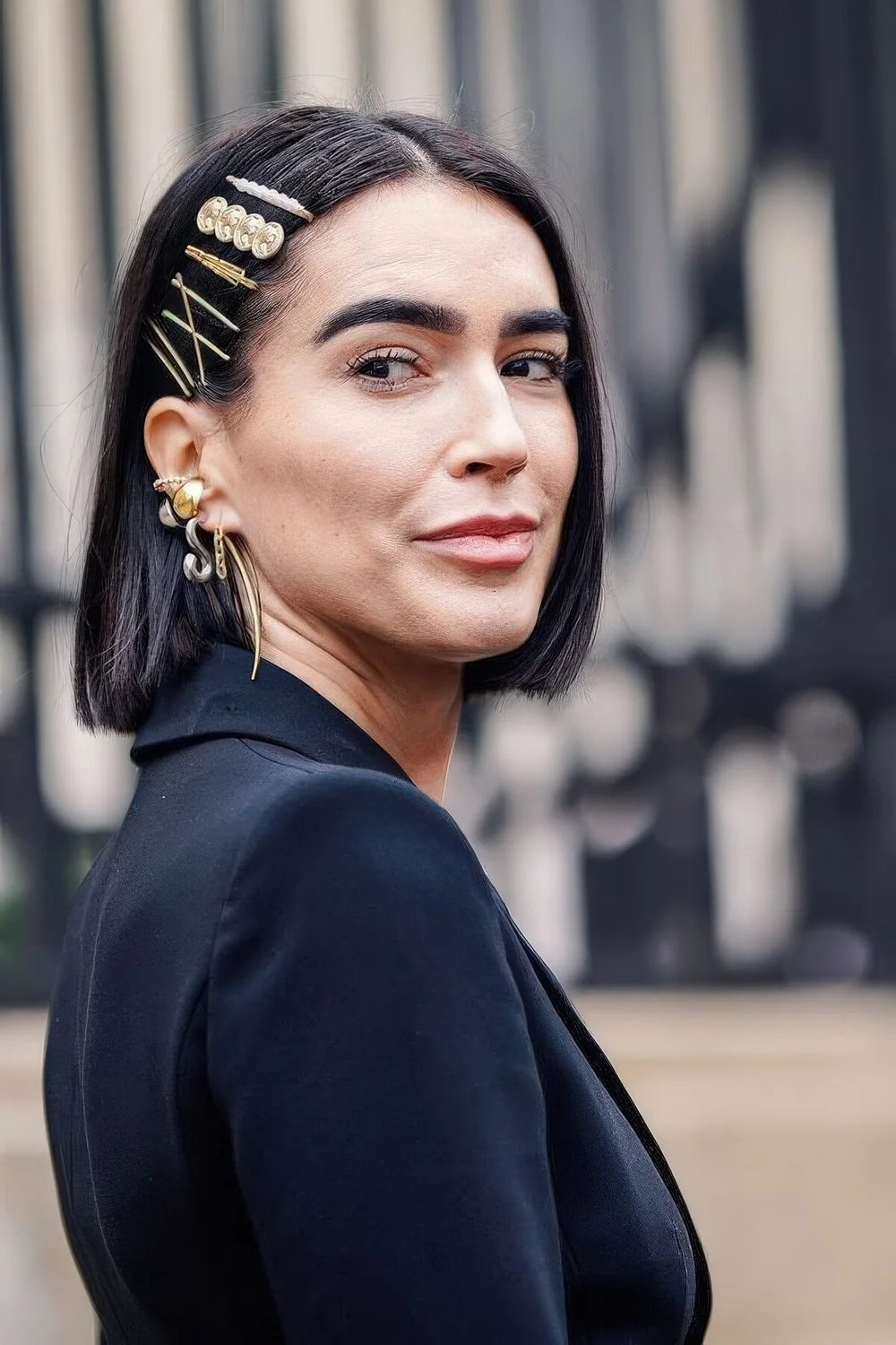Long black bob with a whole arrangement of gold and pearl hair pins.