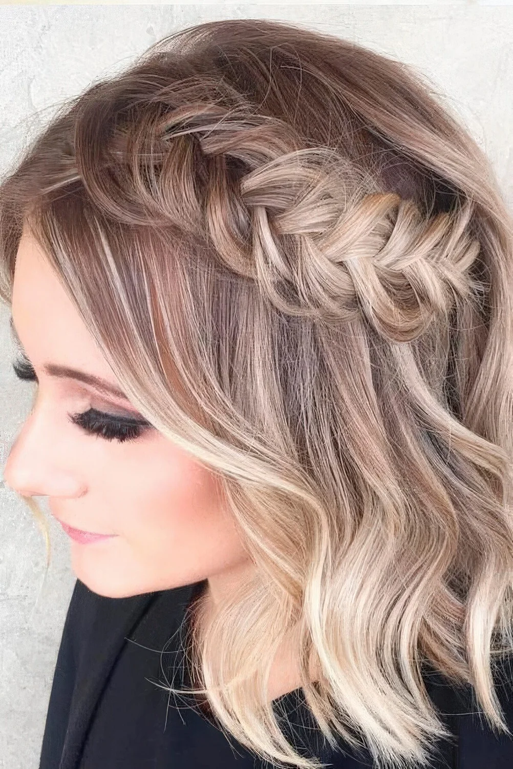 Chic half updo with a loose braid and hair down.