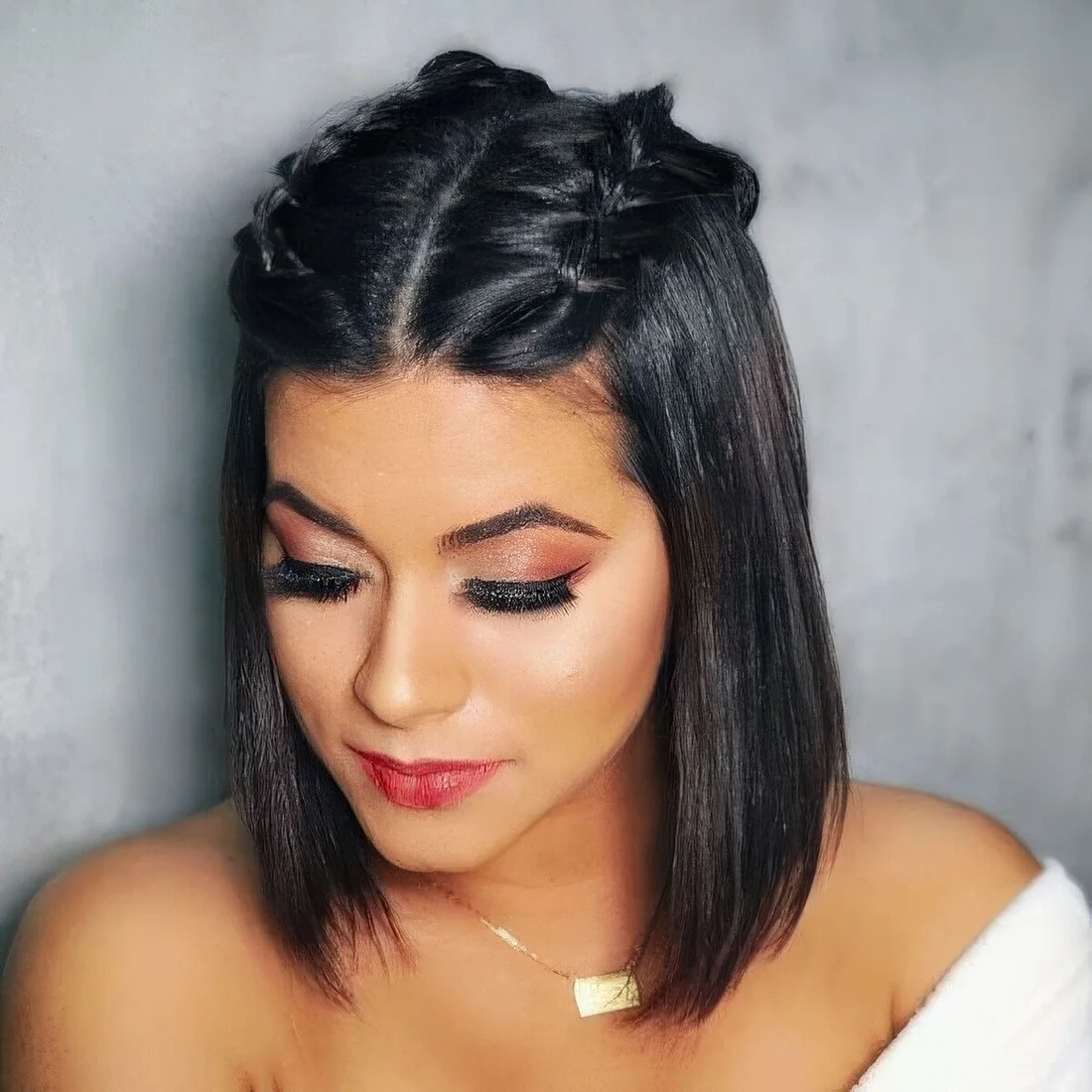 Long black bob with straight hair and two braids on top.