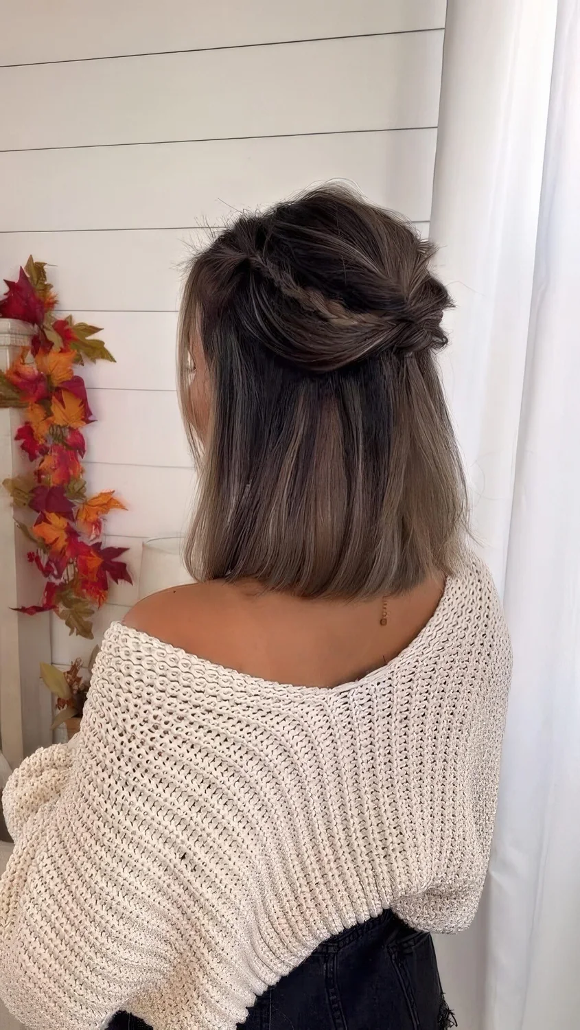 Medium hair half updo with a bump, twists and braids and straight hair down.