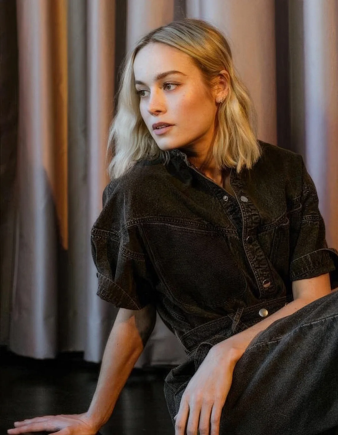 Brie Larson rocking a blonde collarbone bob with slight waves and middle part.