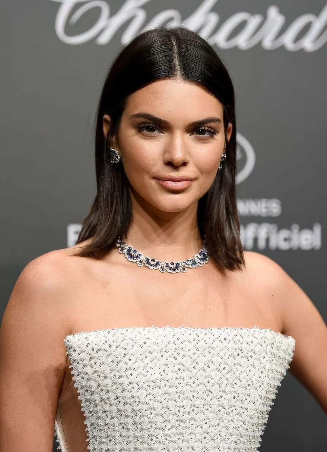 Kendall Jenner wearing a dark brown collarbone bob with middle part.