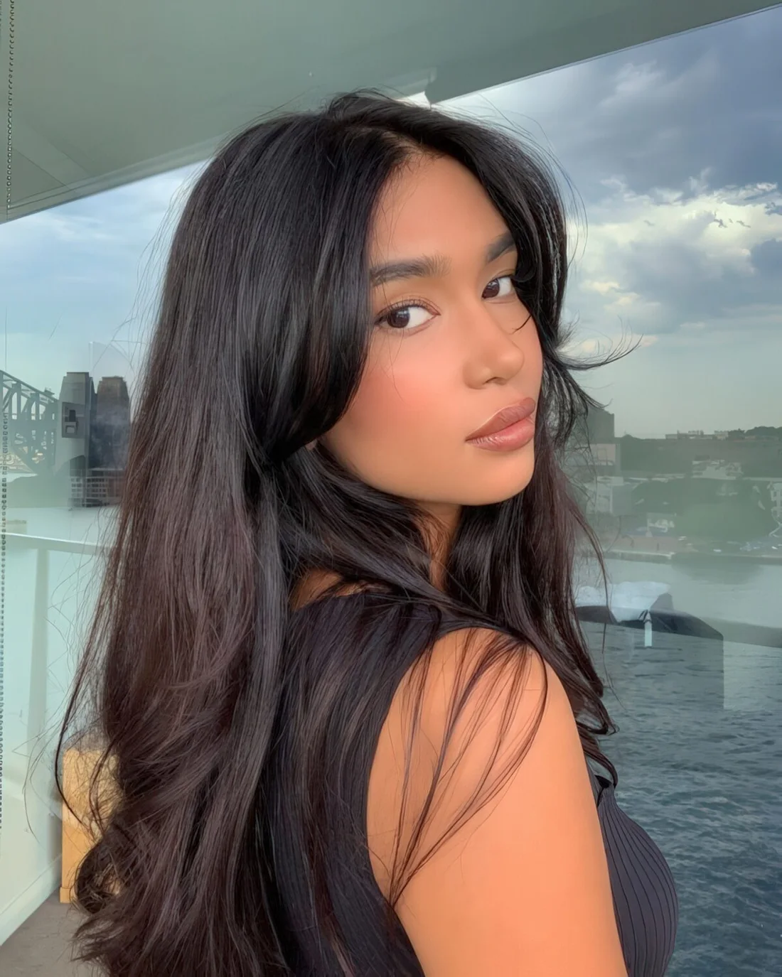 Long black hair with curtain bangs and waves down.